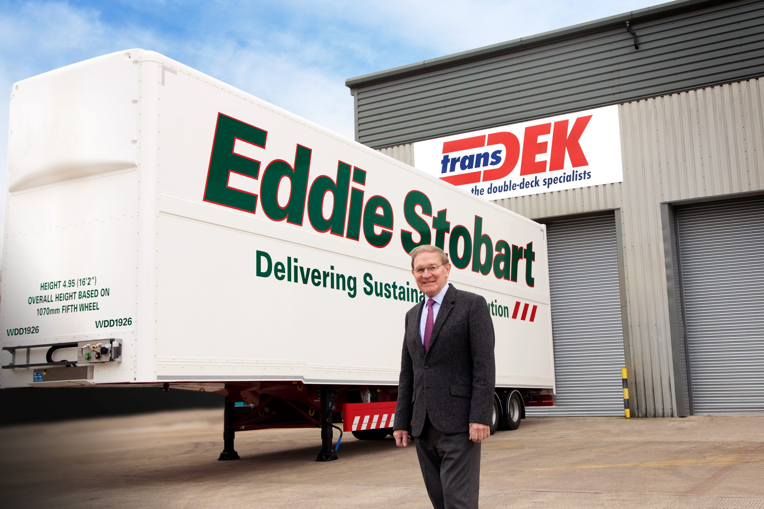 Transdek CEO and Founder Mark Adams in front of a Queens Award winning Wedge trailer